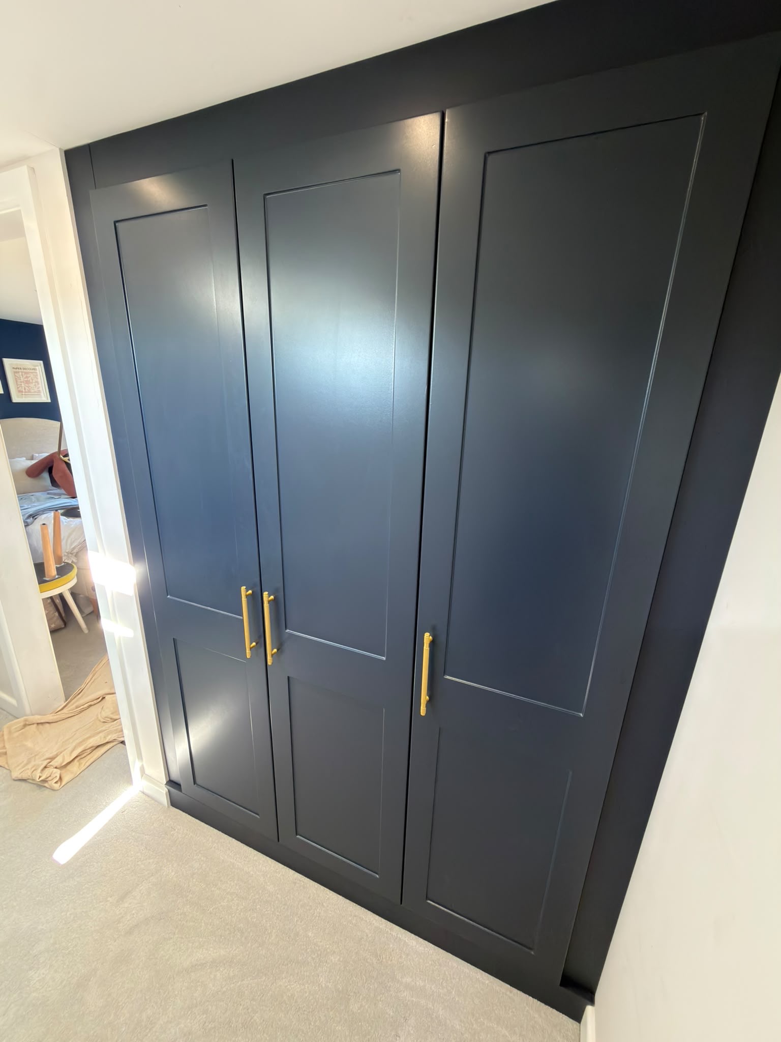 Indigo Blue Rockingham shaker wardrobe doors with brushed brass handles in the St Albans loft bedroom