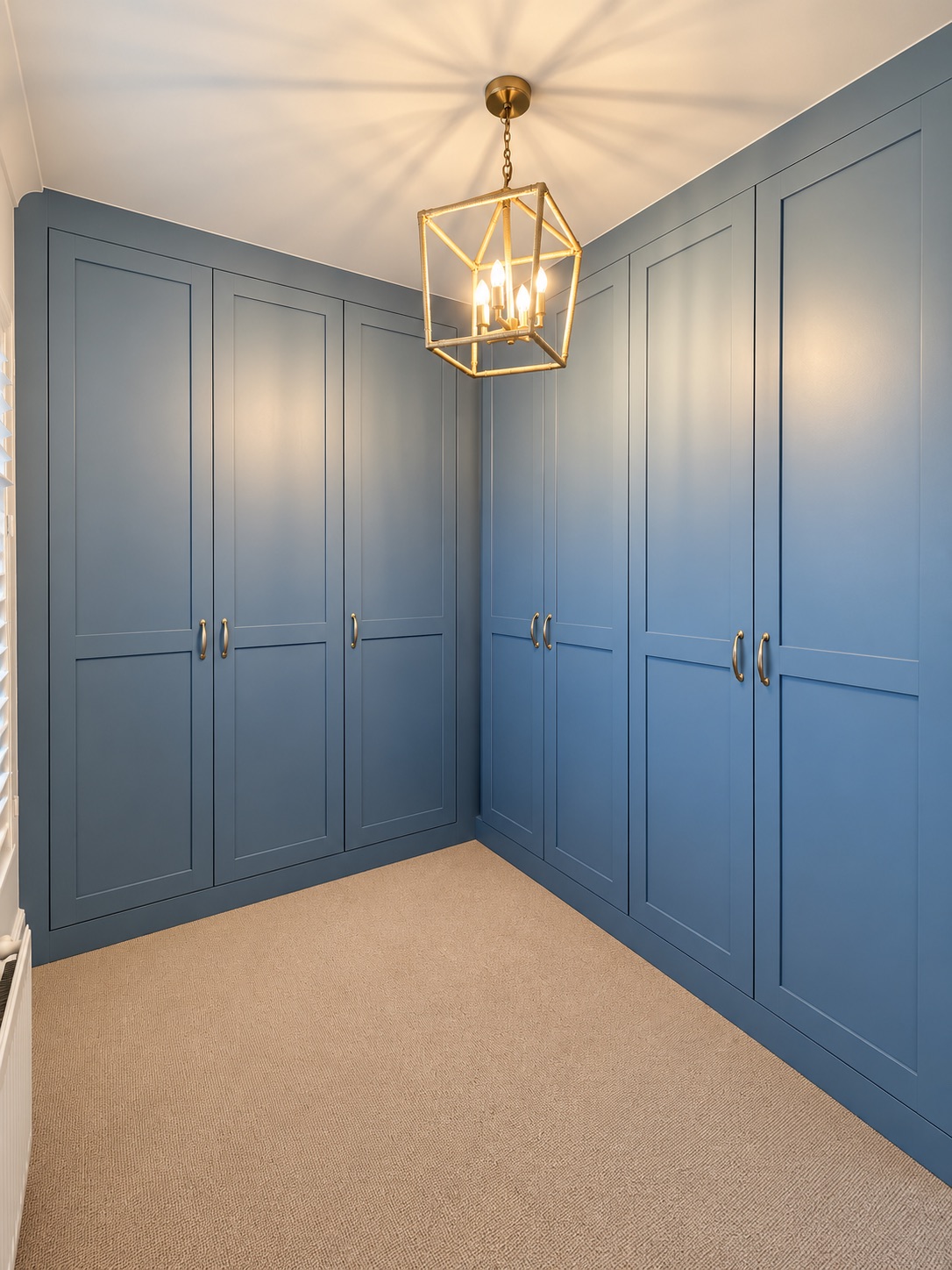 Blue Vein painted fitted wardrobes in Southend forming an L-shaped dressing room