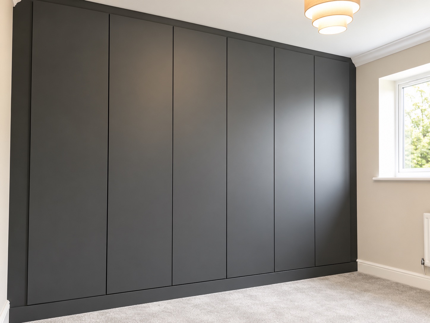 Matt Onyx handleless fitted wardrobes installed in an Ipswich bedroom
