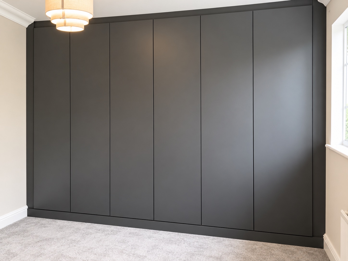 Completed Ipswich fitted wardrobe project with a symmetrical run of matt Onyx doors