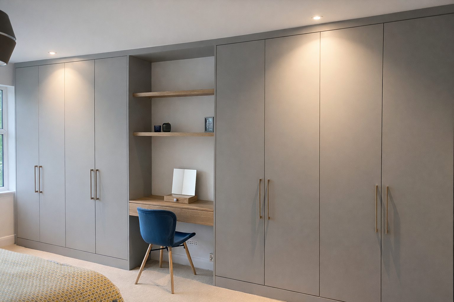 Grey fitted wardrobes with a central dressing table and open shelving