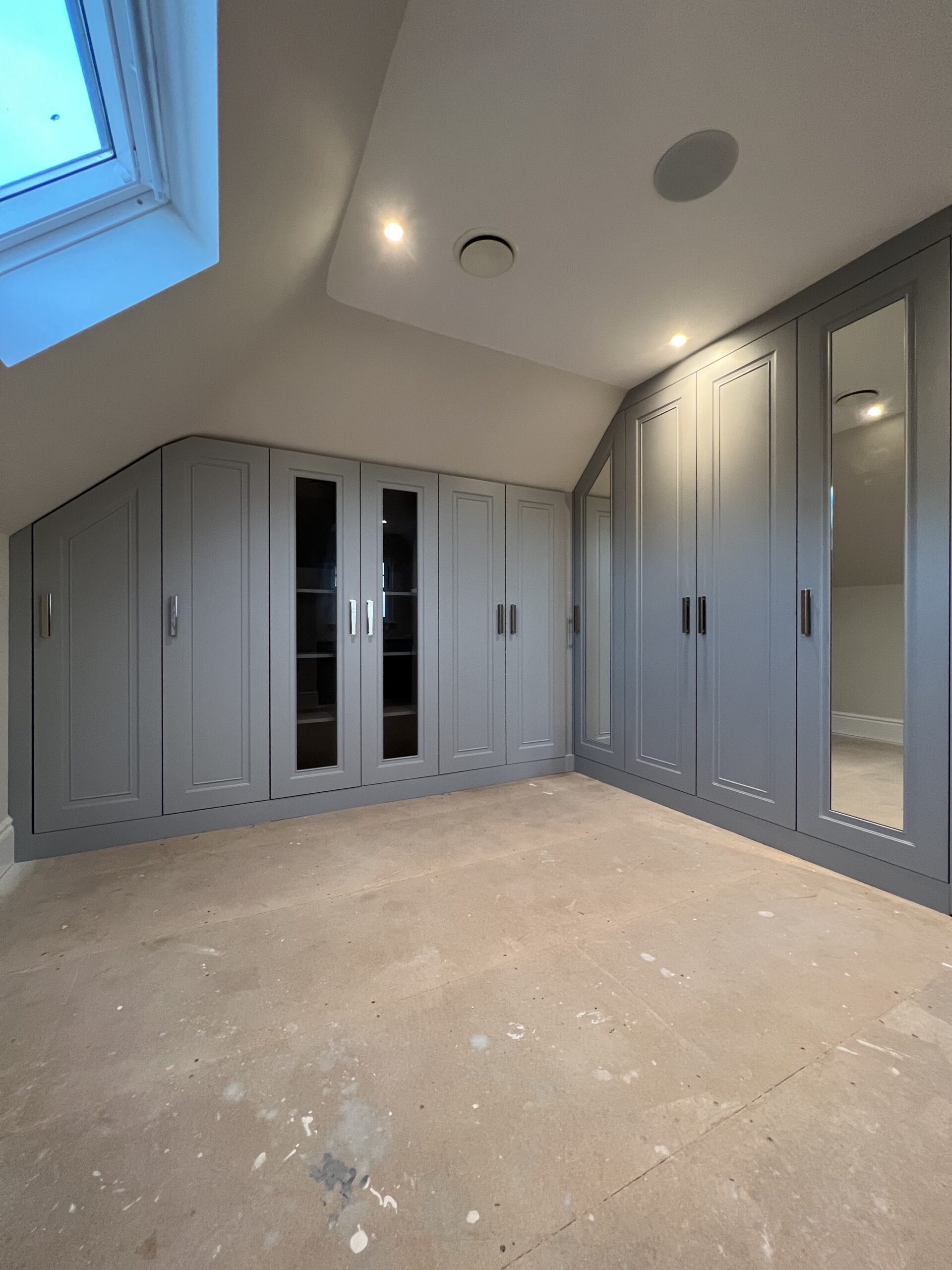 Goodwood bespoke fitted wardrobes designed around an angled bedroom ceiling