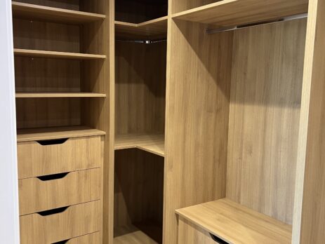 Custom-designed walk-in wardrobe with soft-close drawers and a Carbon Grey surround, maximizing storage space in a traditional Essex home.