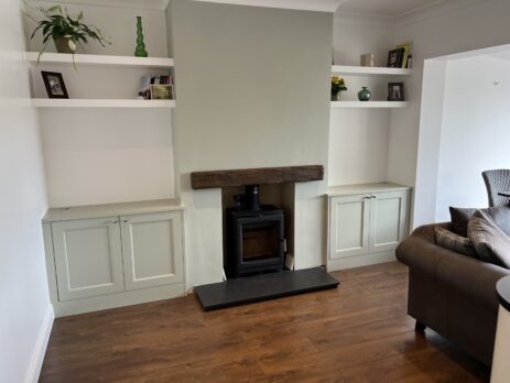 Custom alcove units with shaker-style doors and a bespoke television stand in a modern living room.