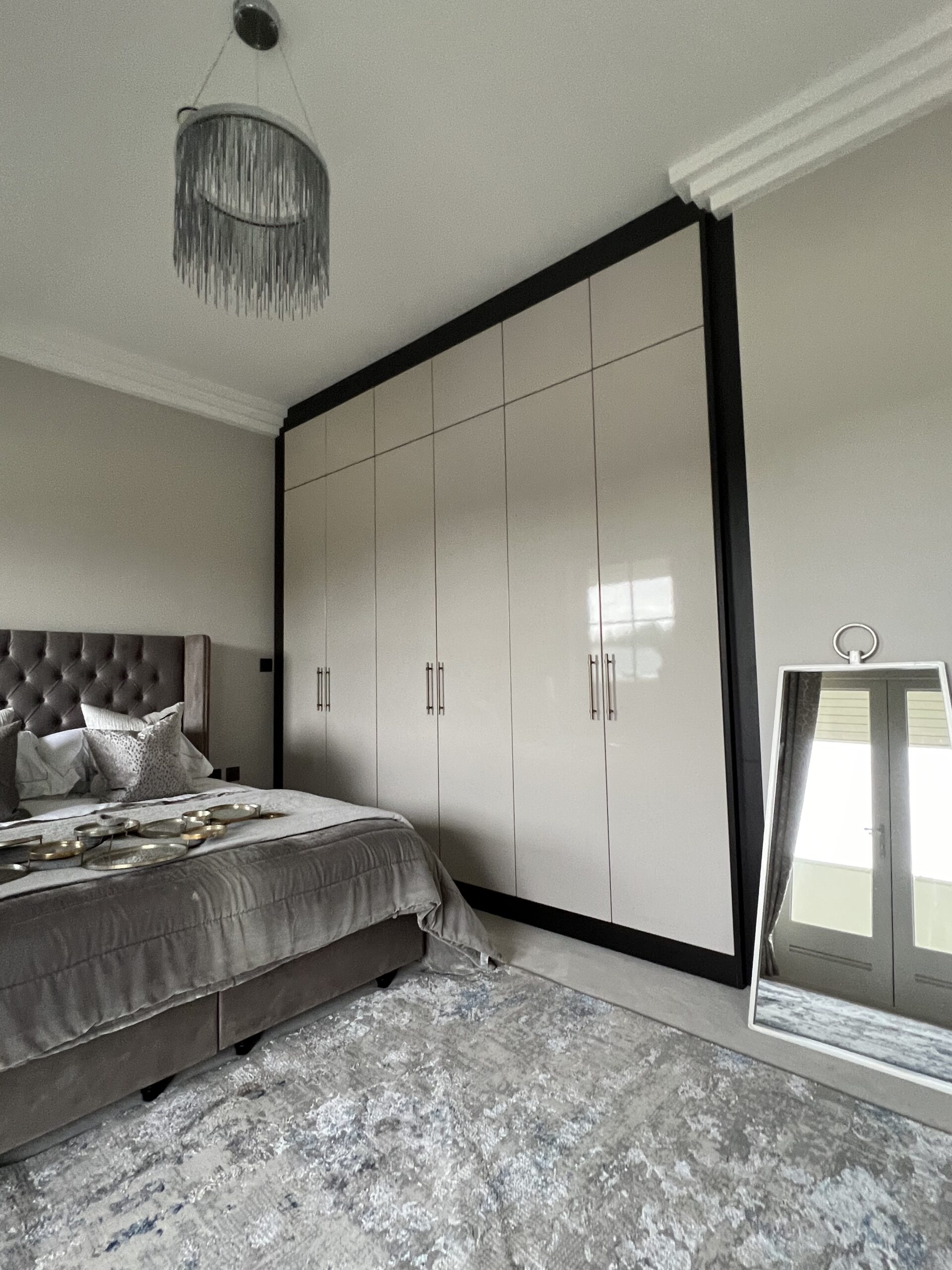 High Gloss Cashmere fitted wardrobes with Black Brown Sorano Oak framing and top boxes in Hertford Heath Hertfordshire