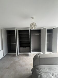 Interior of bespoke wardrobe with anthracite linen finish and soft-close drawers.