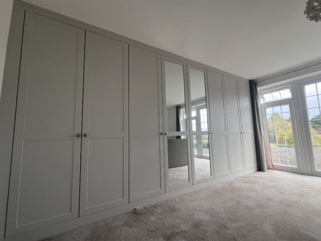 Dove grey Rockingham Range wardrobe enhancing a bright Essex bedroom.