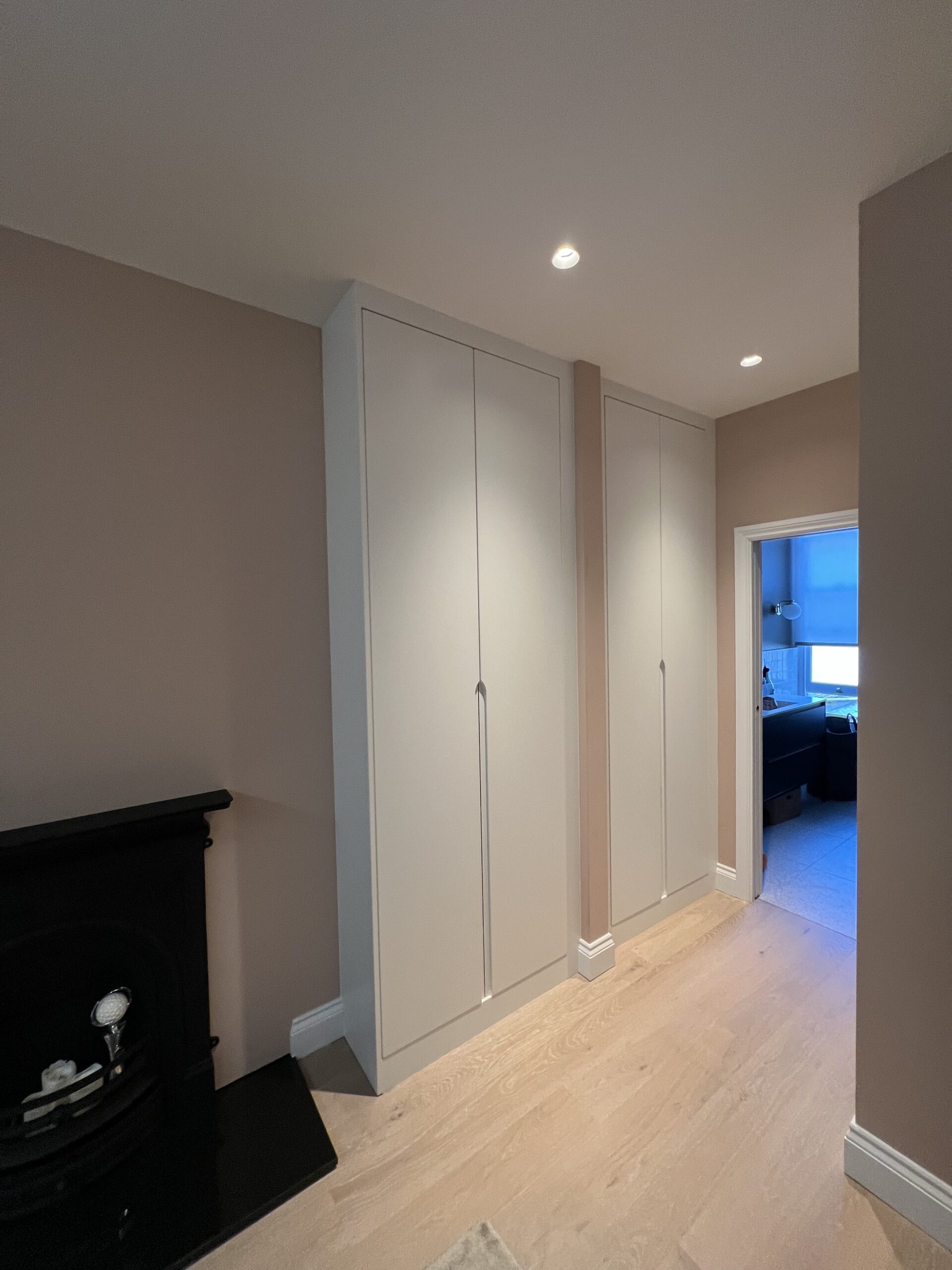 Pure White bespoke fitted wardrobes with custom J-pull doors fitted into Victorian alcoves in Battersea London