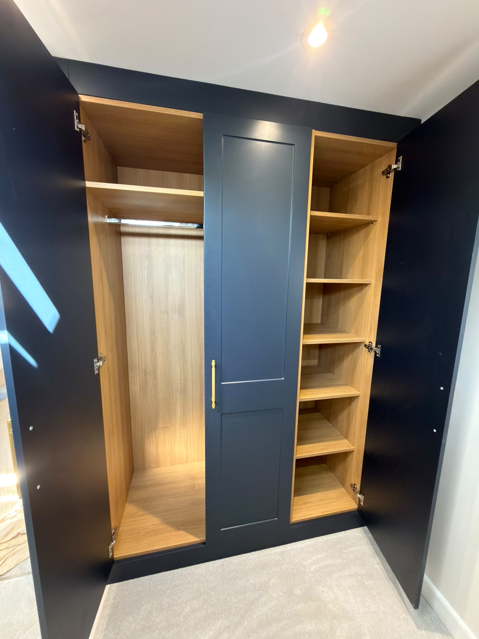 Lancaster Oak wardrobe interiors with long hanging and adjustable shelving in the St Albans loft bedroom